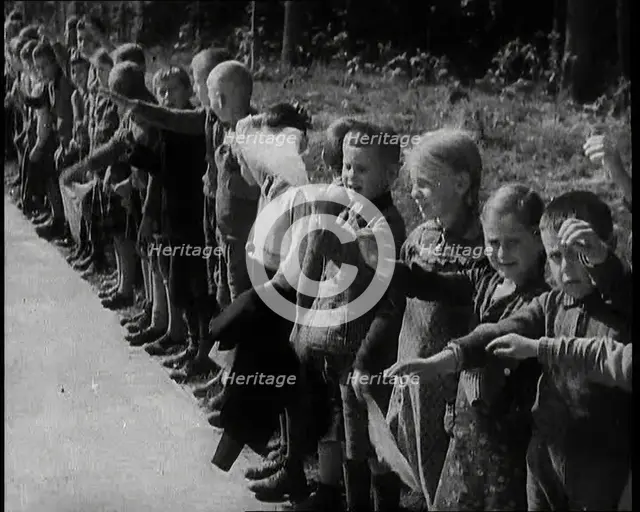 German Children Standing By the Side of a New Road, Some of Them Raising Their Arms in a..., 1937. Creator: British Pathe Ltd.