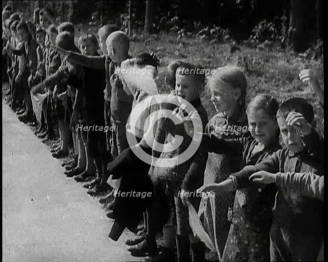 German Children Standing By the Side of a New Road, Some of Them Raising Their Arms in a..., 1937. Creator: British Pathe Ltd.