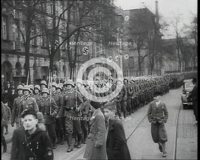 German Civilians Watching German Troops Moving Through the Rhineland, 1936. Creator: British Pathe Ltd.