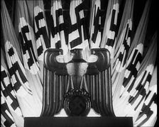 German Eagle Statue With German Flags Behind Bearing the Nazi Swastika, 1937. Creator: British Pathe Ltd