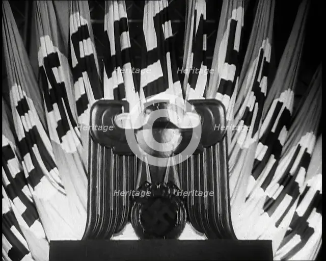 German Eagle Statue With German Flags Behind Bearing the Nazi Swastika, 1937. Creator: British Pathe Ltd.