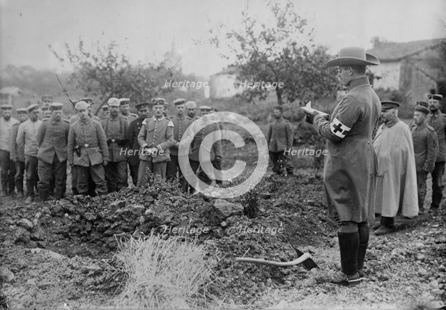 German Field chaplain burying French Officer who died in hospital, 1914. Creator: Bain News Service.