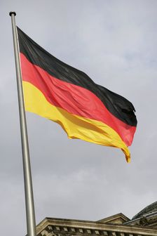German flag next to the Reichstag building, Berlin, Germany, 2025. Creator: LTL