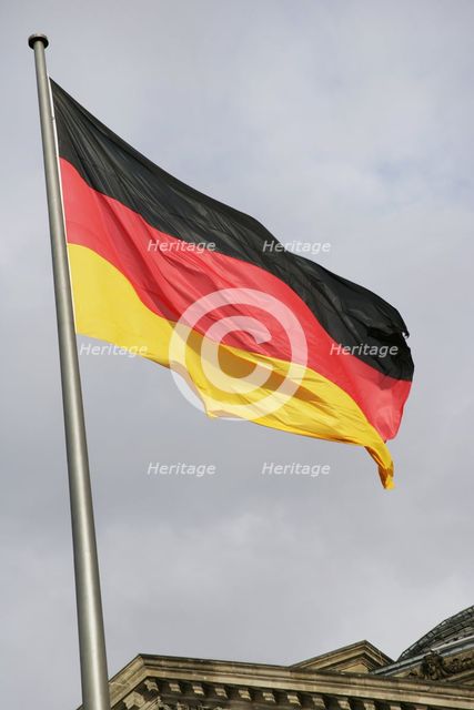 German flag next to the Reichstag building, Berlin, Germany, 2025.  Creator: LTL.