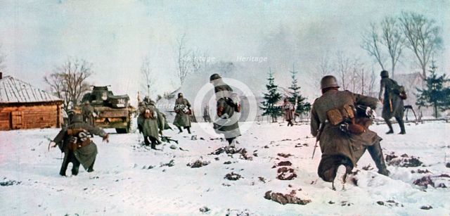 German infantrymen following a tank towards Moscow in the snow, Russia, 1941. Artist: Unknown