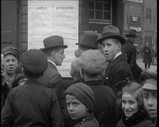German People Reading a Poster up on a Wall, 1921. Creator: British Pathe Ltd