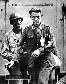 German prisoner of war arriving in England, escorted by an American soldier, 1944
