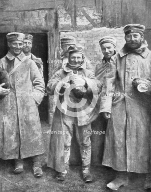 German prisoners of war with their ration of bread, 1915. Artist: Unknown