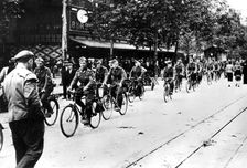 German soldier cycling through the streets of Paris, June 1940