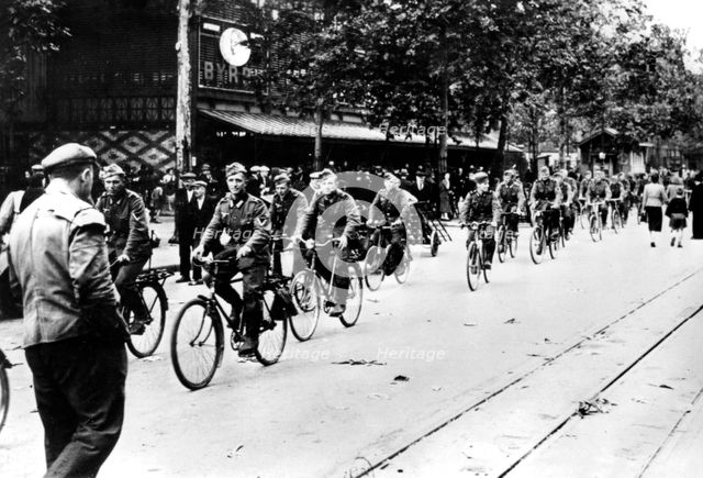 German soldier cycling through the streets of Paris, June 1940. Artist: Unknown