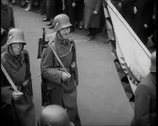 German Soldiers Marching Down a Street as a Crowd Watches, 1930s. Creator: British Pathe Ltd