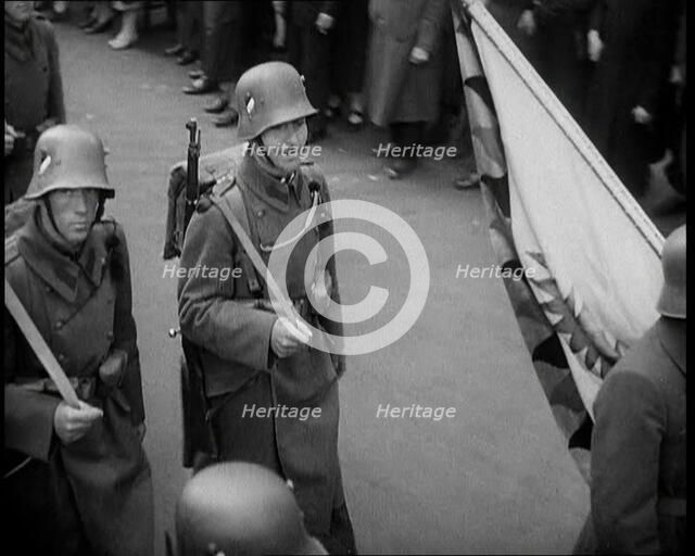 German Soldiers Marching Down a Street as a Crowd Watches, 1930s. Creator: British Pathe Ltd.