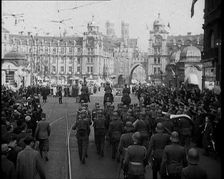 German Soldiers Marching Down a Street as a Crowd Watches, 1930s. Creator: British Pathe Ltd