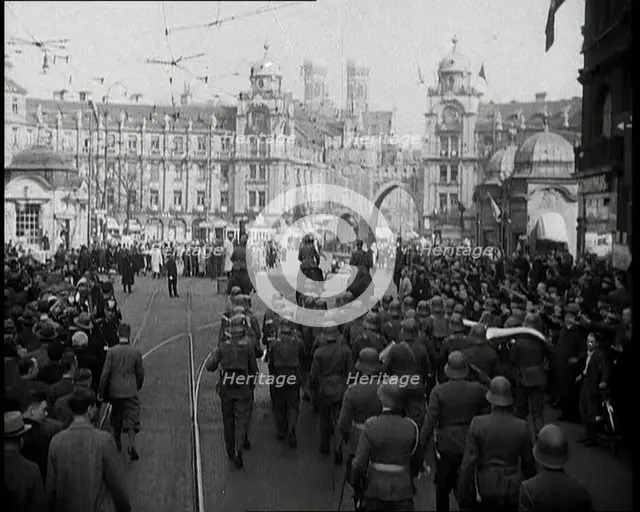 German Soldiers Marching Down a Street as a Crowd Watches, 1930s. Creator: British Pathe Ltd.