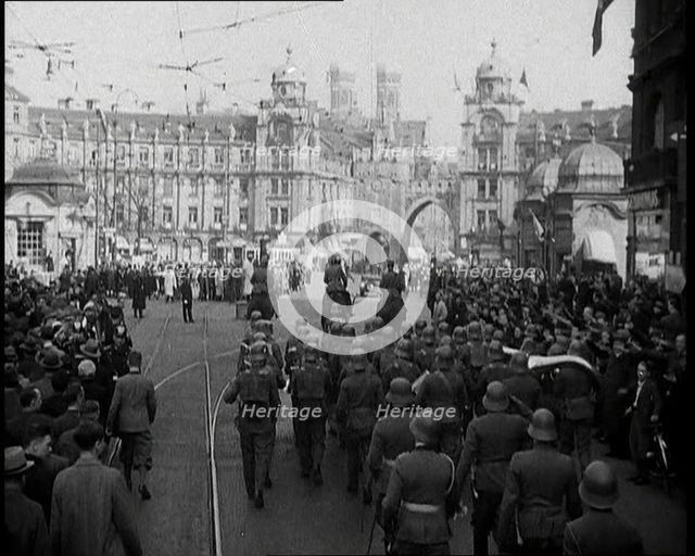 German Soldiers Marching Down a Street as a Crowd Watches, 1930s. Creator: British Pathe Ltd.