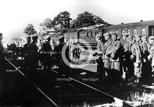 German soldiers awaiting transportation in a railway station in the Paris suburbs, August 1940. Artist: Unknown