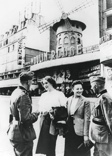 German soldiers chatting up French women outside the Moulin Rouge, occupied Paris, June 1940