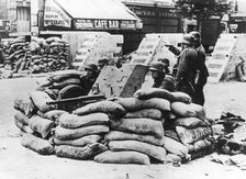 German soldiers with captured French barricade, near Paris, June 1940