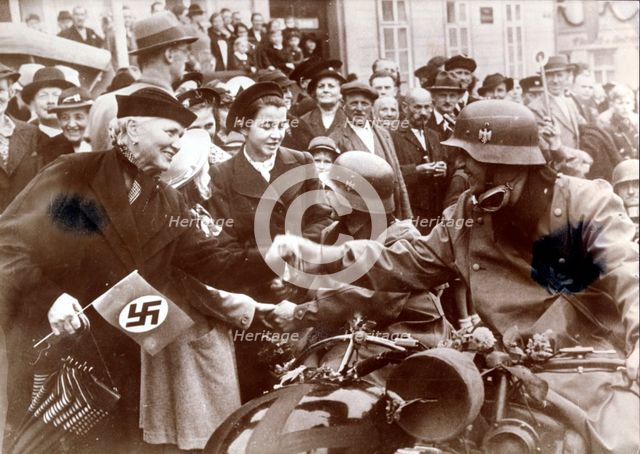 German troops are greeted by a crowed in Luknov, Czech Republic, c1939. Creator: Unknown.