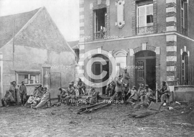 German troops sitting on the steps of the Vareddes Town Hall, France, 1914. Artist: Unknown