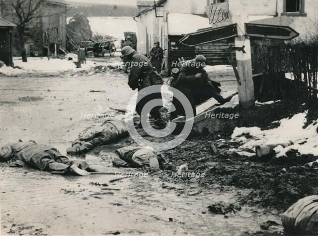 German troops stripping the equipment of dead American troops, Belgium. Artist: Unknown