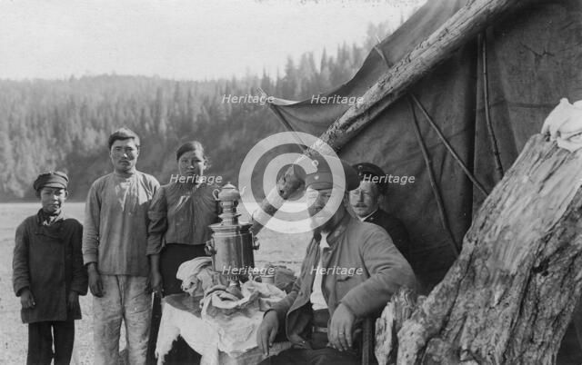 G.I. Ivanov and a Shoria Family at the Table with Samovar Near the Tent, 1913. Creator: GI Ivanov.