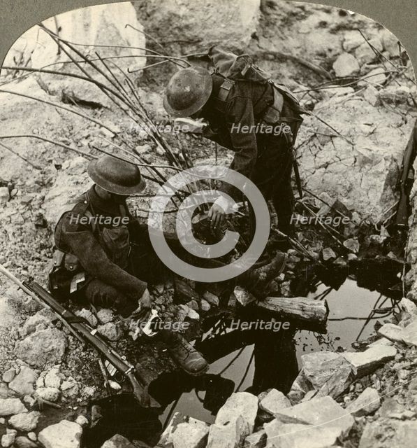 Giving water to a wounded pal, Hooge, Ypres, Belgium, World War I, 1914-1918.Artist: Realistic Travels Publishers