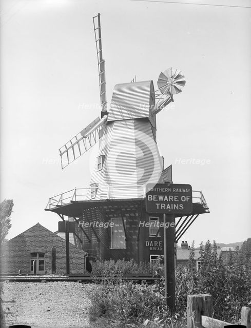 Gibbet smock mill from the opposite side of the Ashford and Hasting Railway line, East Sussex, 1934. Creator: HES Simmons.