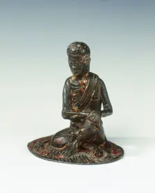 Gilt bronze statue of a lohan seated on a rush mat, late Ming dynasty, China, 1600-1644. Creator: Unknown