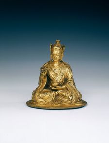 Gilt brass Padmasambhava holding attributes, Tibet, 16th-17th century. Creator: Unknown