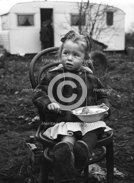 Gipsy girl eating, Lewes, Sussex, 1964. 