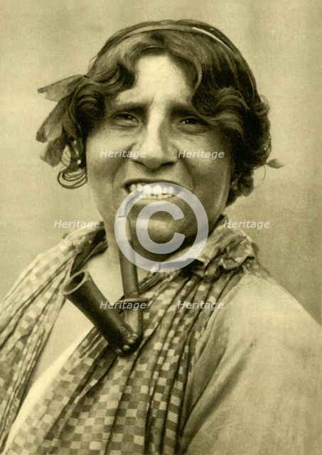 Gipsy woman smoking a pipe, Burgenland, Austria, c1935. Creator: Unknown.
