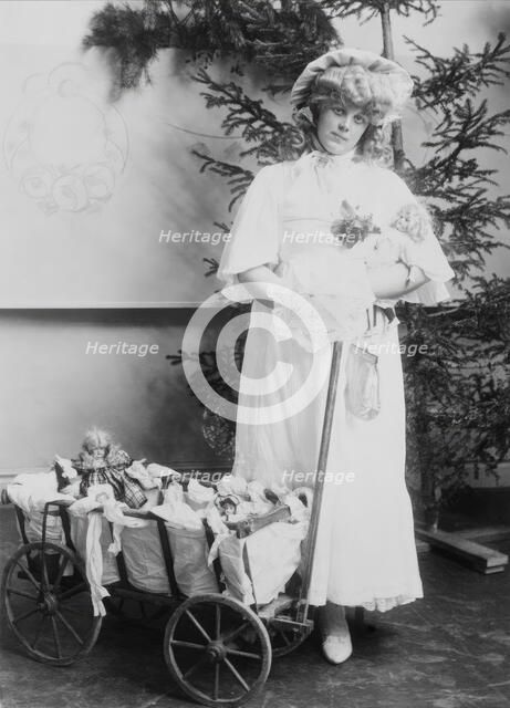 Girl with dolls and doll carriage, 1900.  Creator: Unknown.