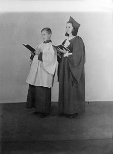Girl and boy chorister, (Isle of Wight?), c1935. Creator: Kirk & Sons of Cowes