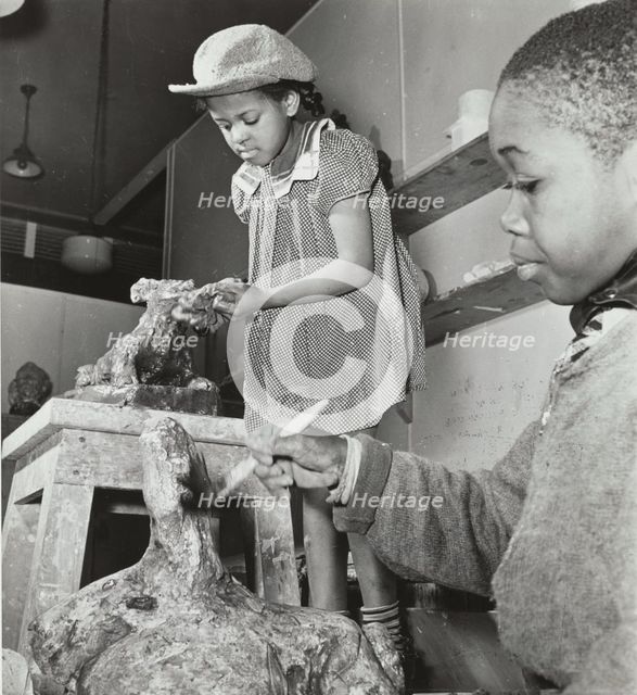 Girl and boy sculpting, Harlem Art Center, 1939. Creator: Berenice Abbott.