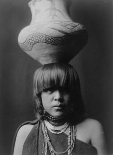 Girl and jar-San Ildefonso, c1927. Creator: Edward Sheriff Curtis