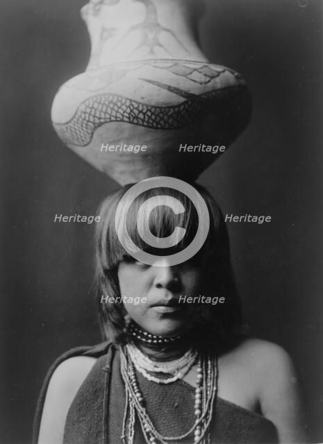 Girl and jar-San Ildefonso, c1927. Creator: Edward Sheriff Curtis.