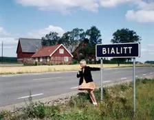Girl by a road sign for Bialitt, Sweden. Creator: Torkel Lindeberg