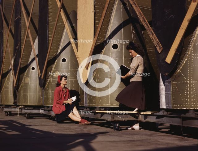 Girl inspectors at the Long Beach, Calif., plant of Douglas Aircraft Company make a careful..., 1942 Creator: Alfred T Palmer.