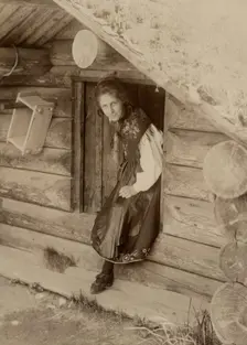 Girl looks out from a doorway, 1890-1920. Creator: Helene Edlund