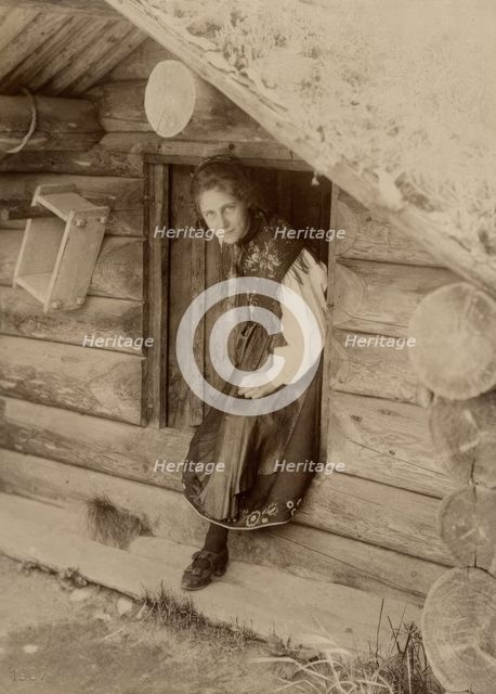 Girl looks out from a doorway, 1890-1920. Creator: Helene Edlund.