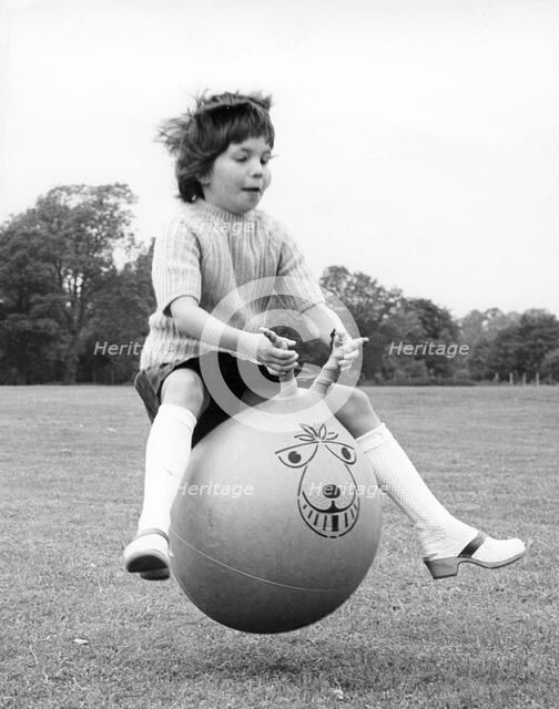 Girl on a space hopper, 1970s.