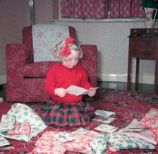 Girl opening her Christmas cards and presents, c1955. Creator: Arthur Charles Kirby Ware