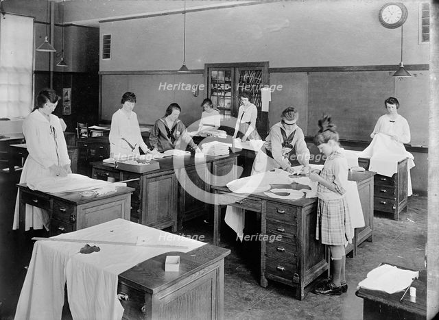 Girl Scouts - War Sewing with Red Cross, 1917. Creator: Harris & Ewing.