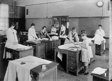 Girl Scouts - War Sewing with Red Cross, 1917. Creator: Harris & Ewing
