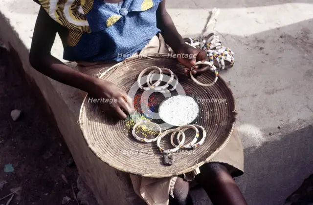 Girl selling hand-made bracelets, Mali, 1990. Creator: Amanda Waite.