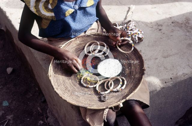 Girl selling hand-made bracelets, Mali, 1990. Creator: Amanda Waite.