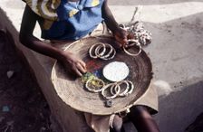 Girl selling hand-made bracelets, Mali, 1990. Creator: Amanda Waite