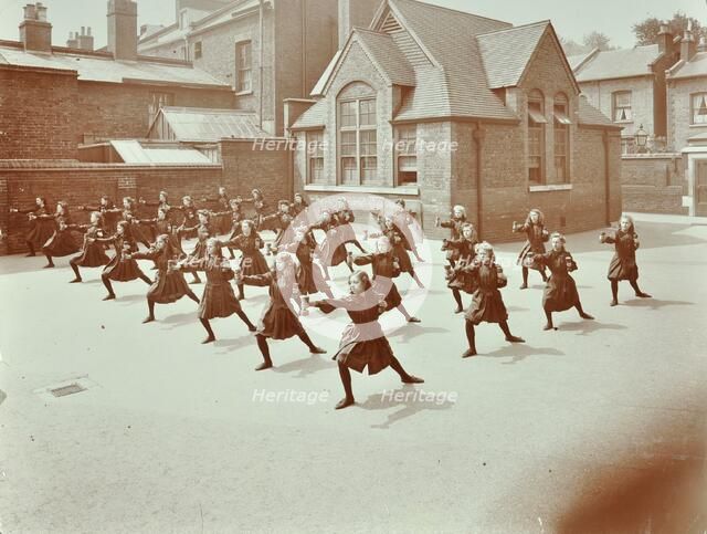 Girls doing drill in the playground, Wilton Road School, London, 1907. Artist: Unknown.