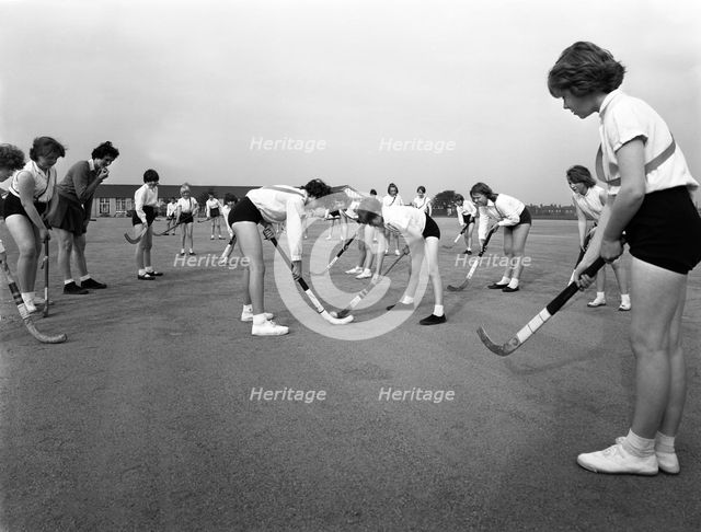 Girls hockey match, Airedale school, Castleford, West Yorkshire, 1962. Creator: Michael Walters.